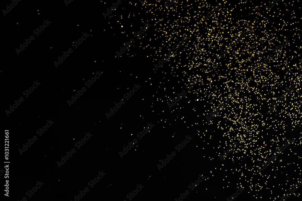 Beautiful shiny golden glitter on black background, top view Beautiful shiny golden glitter on black background, top view
