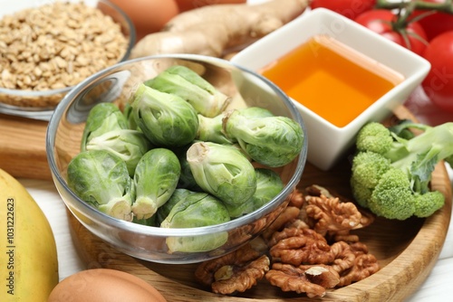 Different fresh products rich in melatonin on white table, closeup photo