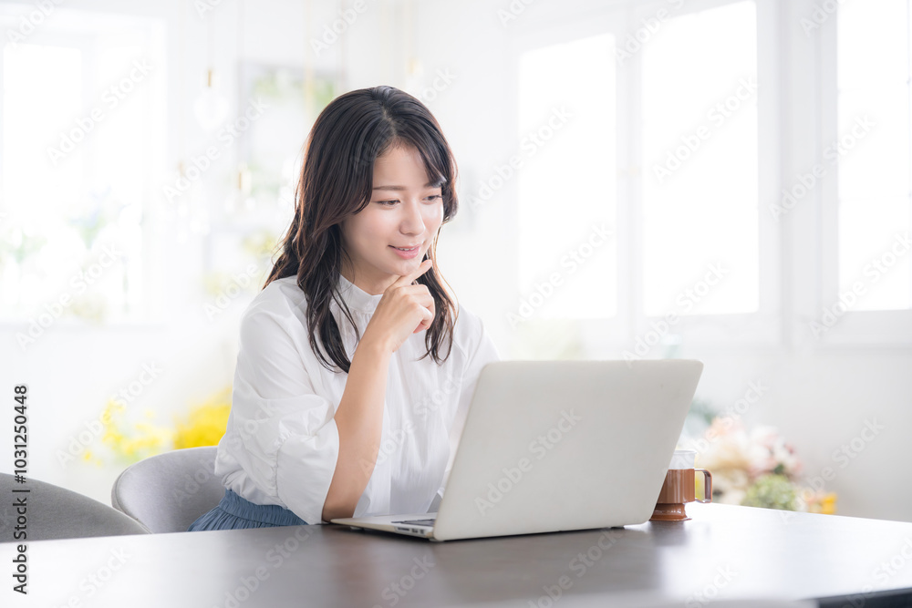 Young woman smiling and worried while looking at computer Image of a young pretty woman changing jobs, studying, etc. Young woman smiling and worried while looking at computer Image of a young pretty woman changing jobs, studying, etc.