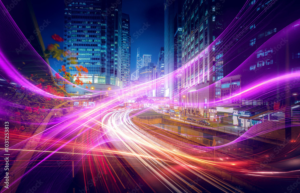 Night time view of a busy highway with traffic light trails. A cityscape of tall buildings. Night time view of a busy highway with traffic light trails. A cityscape of tall buildings.