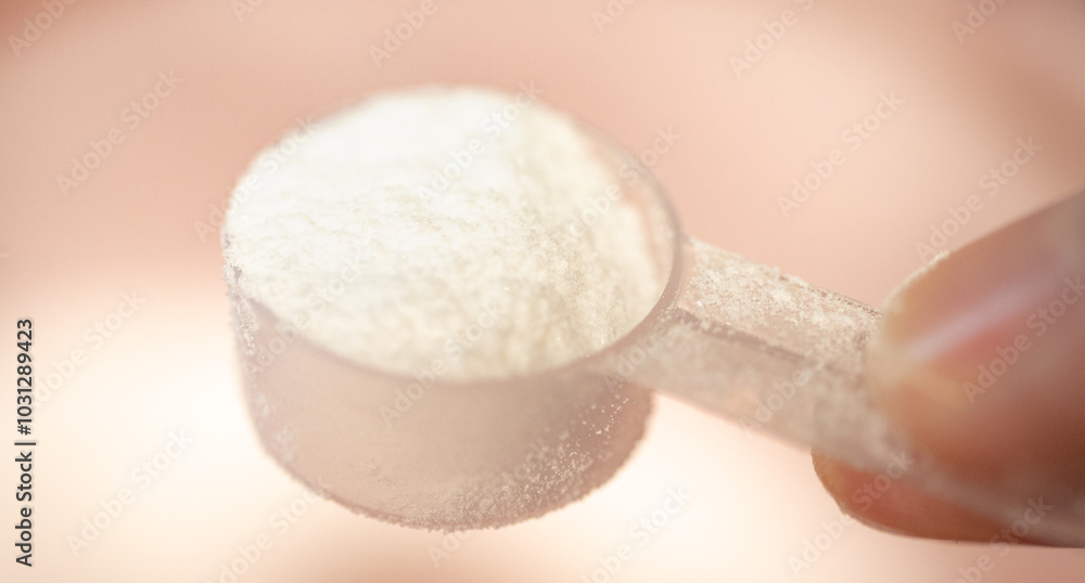 Creatine, food supplement. Macro of a man's hand holding a scoop with creatine.
Creatine, food supplement. Macro of a man's hand holding a scoop with creatine.