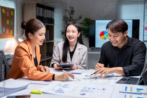 Asian businesspeople having meeting and discussing about financial documents at office