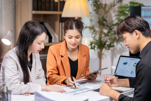 Group of asian business people analyzing business data on office desk