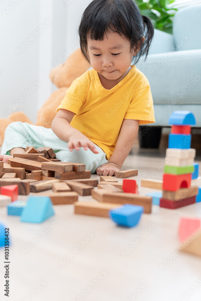 Happy Asian child playing and learning toy blocks. children are very happy and excited at home. child have a great time playing, activities, development, attention deficit hyperactivity disorder Happy Asian child playing and learning toy blocks. children are very happy and excited at home. child have a great time playing, activities, development, attention deficit hyperactivity disorder