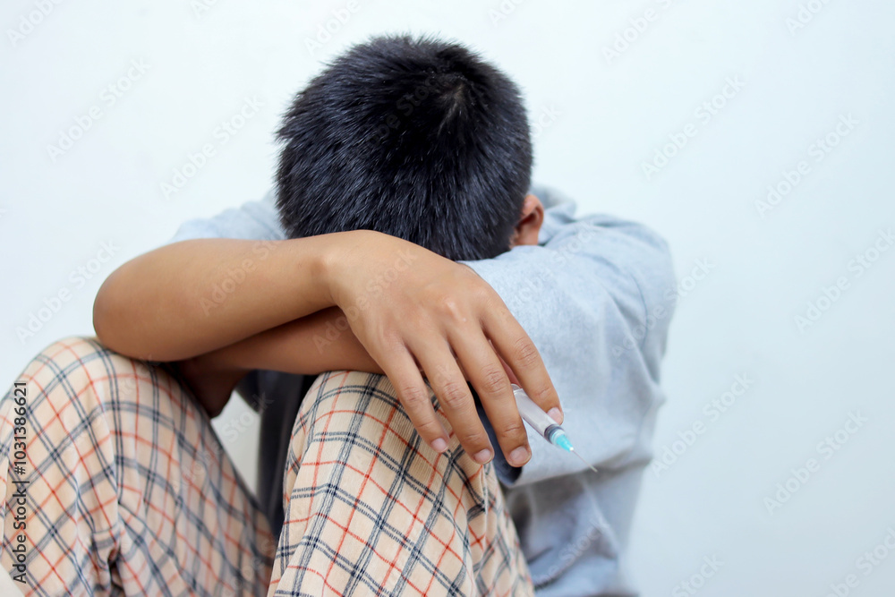 Depression Man Crying Hug Her Knee While Holding Syringe Sitting on The Floor
Depression Man Crying Hug Her Knee While Holding Syringe Sitting on The Floor