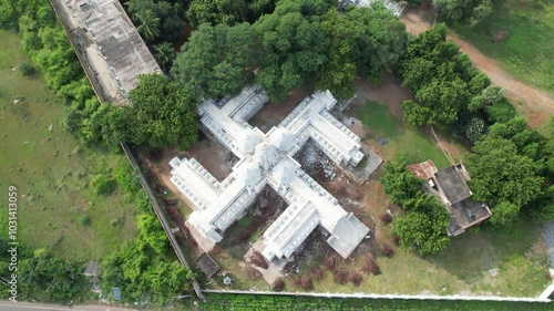 Aerial drone shot of temple from above surrounded by trees. photo