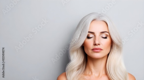 Aging woman with thinning gray hair, visibly reversing into a youthful self, dark hair flowing, skin glowing without age marks photo