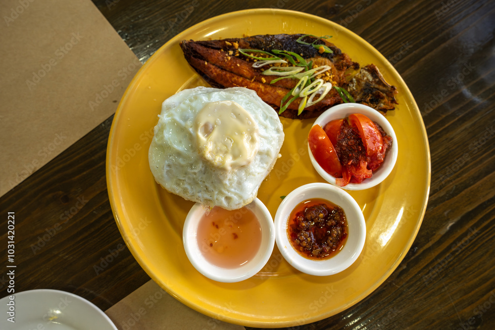 One of the Filipino style breakfast grilled bangus fish with garlic rice
One of the Filipino style breakfast grilled bangus fish with garlic rice
