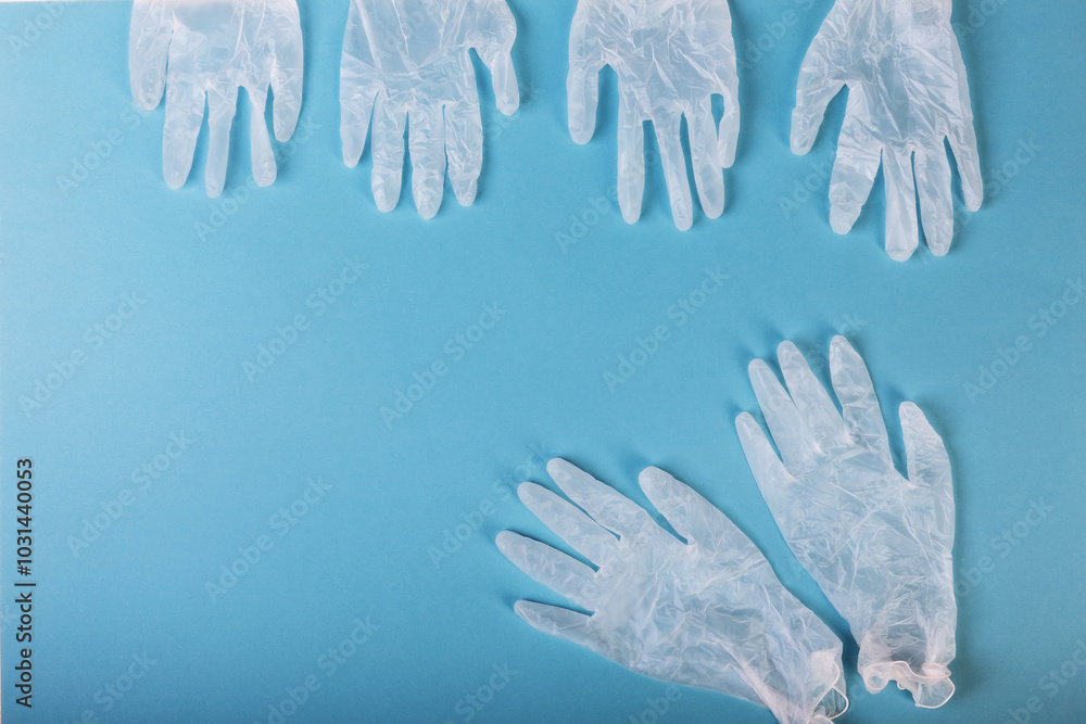 White surgical gloves are isolated on the blue background. The concept protects against infection or contamination White surgical gloves are isolated on the blue background. The concept protects against infection or contamination
