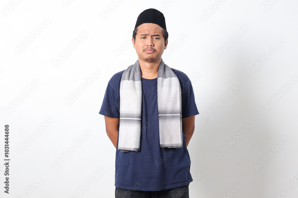 Portrait of unhappy Asian muslim man wearing sarung scarf feeling depressed and disappointed. Isolated image on white background Portrait of unhappy Asian muslim man wearing sarung scarf feeling depressed and disappointed. Isolated image on white background