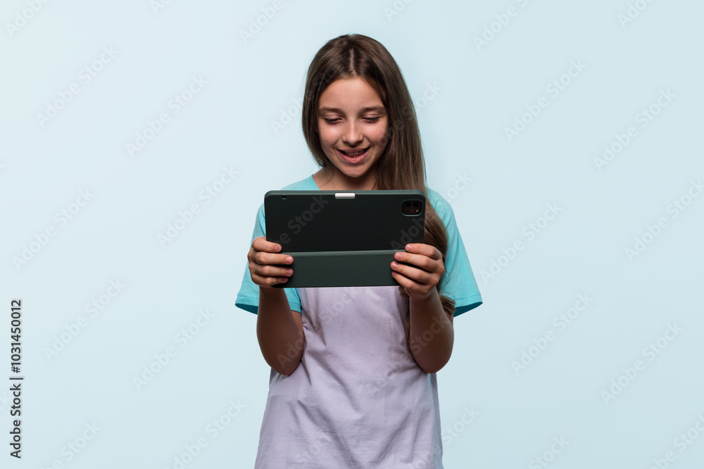 Girl using tablet for entertainment or learning. Girl using tablet for entertainment or learning.