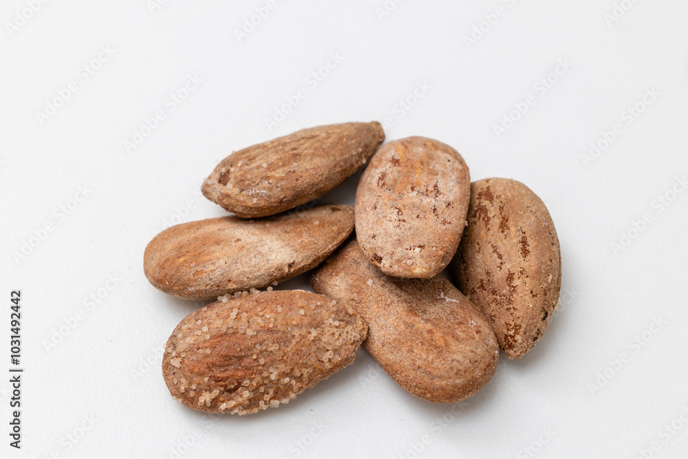 roasted and salted almonds on wooden table roasted and salted almonds on wooden table
