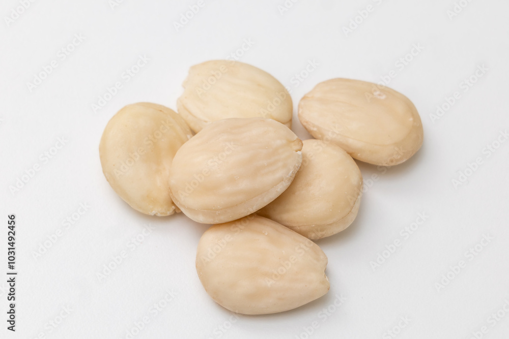 raw almonds on wooden table raw almonds on wooden table