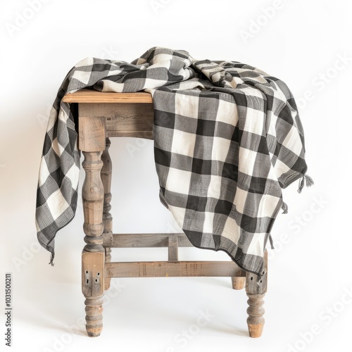 A checkered tablecloth is draped over a wooden table 
