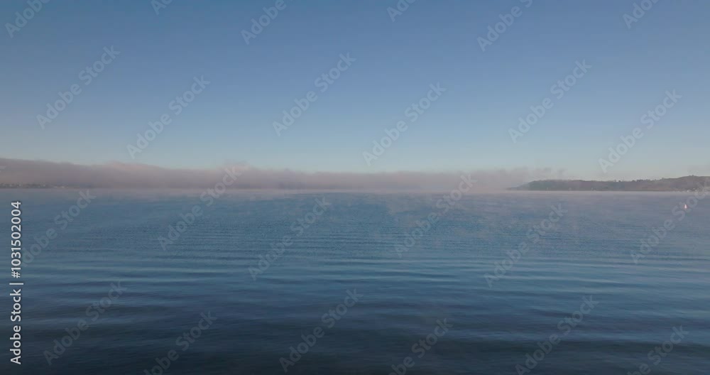 Flying low over Lake Taupo with early morning mist over the water, Taupo, New Zealand Flying low over Lake Taupo with early morning mist over the water, Taupo, New Zealand