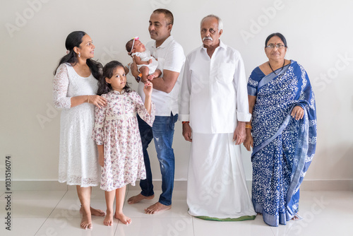 Canvas Print ndian family spending time together, wearing traditional and casual outfits with a baby, a young girl, and grandparents in a high-rise apartment in Kuala Lumpur, Malaysia