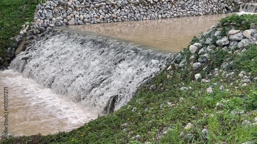 Flow of storm water runoff flowing through two concrete drainage culvert sideway road, stock footage