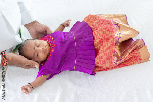 Photography ndian family spending time together, wearing traditional and casual outfits with a baby, a young girl, and grandparents in a high-rise apartment in Kuala Lumpur, Malaysia