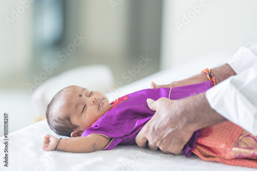 ndian family spending time together, wearing traditional and casual outfits with a baby, a young girl, and grandparents in a high-rise apartment in Kuala Lumpur, Malaysia. photo