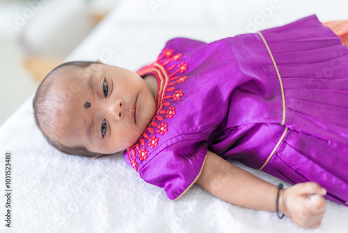 ndian family spending time together, wearing traditional and casual outfits with a baby, a young girl, and grandparents in a high-rise apartment in Kuala Lumpur, Malaysia. photo