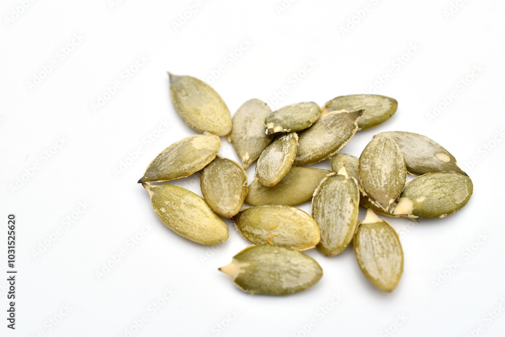 Peeled pumpkin seeds on a white background. Peeled pumpkin seeds on a white background.