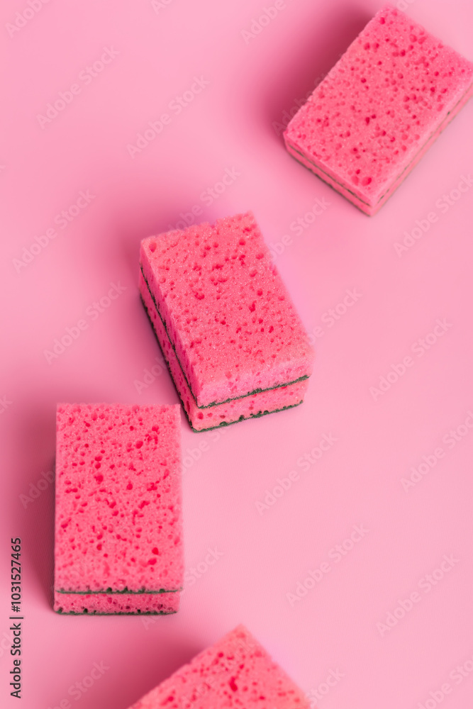 Pink kitchen sponges for washing dishes on a pink background, top view. Homework. Household work. Washing dishes. Pink kitchen sponges for washing dishes on a pink background, top view. Homework. Household work. Washing dishes.