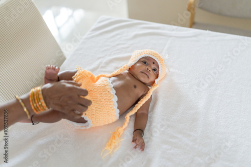 Photography ndian family spending time together, wearing traditional and casual outfits with a baby, a young girl, and grandparents in a high-rise apartment in Kuala Lumpur, Malaysia