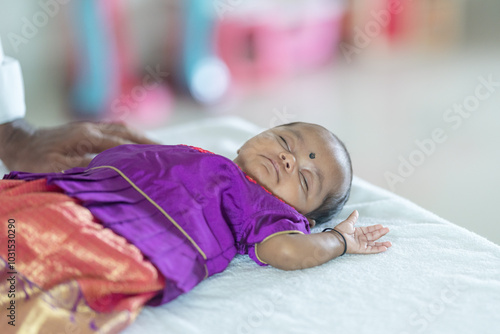 Photography ndian family spending time together, wearing traditional and casual outfits with a baby, a young girl, and grandparents in a high-rise apartment in Kuala Lumpur, Malaysia