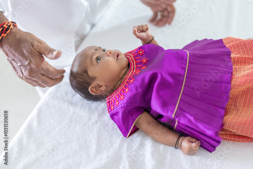 Photography ndian family spending time together, wearing traditional and casual outfits with a baby, a young girl, and grandparents in a high-rise apartment in Kuala Lumpur, Malaysia