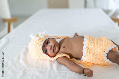 ndian family spending time together, wearing traditional and casual outfits with a baby, a young girl, and grandparents in a high-rise apartment in Kuala Lumpur, Malaysia. photo