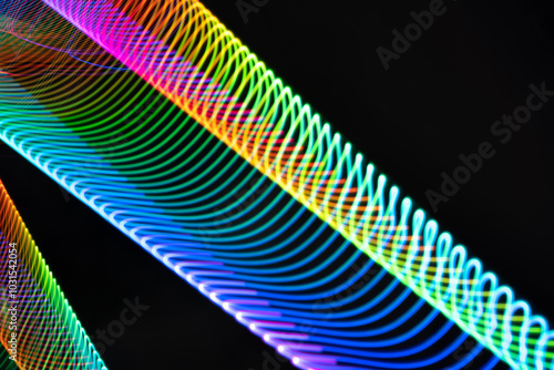 The image is a colorful, abstract representation of a rainbow. The vibrant colors and swirling lines create a sense of movement and energy, evoking a feeling of joy and wonder