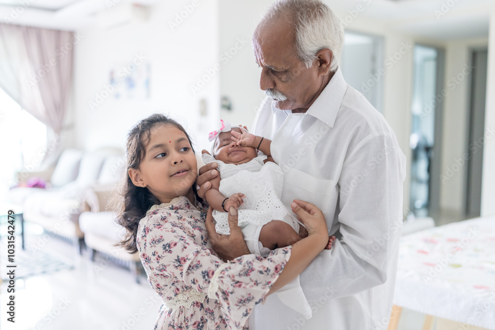 ndian family spending time together, wearing traditional and casual outfits with a baby, a young girl, and grandparents in a high-rise apartment in Kuala Lumpur, Malaysia. ndian family spending time together, wearing traditional and casual outfits with a baby, a young girl, and grandparents in a high-rise apartment in Kuala Lumpur, Malaysia.