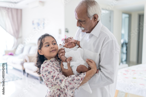 Photography ndian family spending time together, wearing traditional and casual outfits with a baby, a young girl, and grandparents in a high-rise apartment in Kuala Lumpur, Malaysia