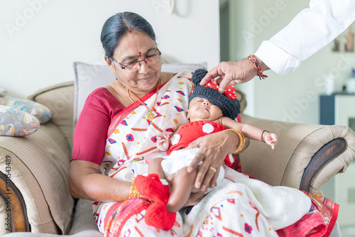 Canvas Print ndian family spending time together, wearing traditional and casual outfits with a baby, a young girl, and grandparents in a high-rise apartment in Kuala Lumpur, Malaysia