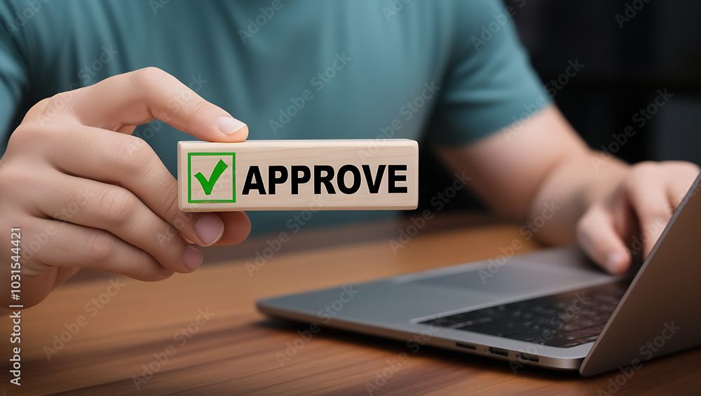 Approved. Businessman holding wooden block with text approve for document approval, assessment, approve the loan, finance agreement, loan, stamp, business. Certified Approved. Businessman holding wooden block with text approve for document approval, assessment, approve the loan, finance agreement, loan, stamp, business. Certified