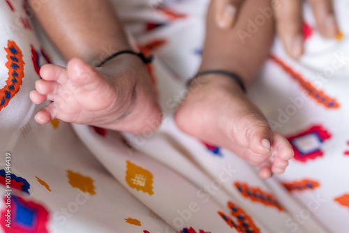 ndian family spending time together, wearing traditional and casual outfits with a baby, a young girl, and grandparents in a high-rise apartment in Kuala Lumpur, Malaysia. photo