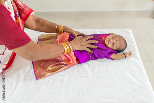 Photography ndian family spending time together, wearing traditional and casual outfits with a baby, a young girl, and grandparents in a high-rise apartment in Kuala Lumpur, Malaysia