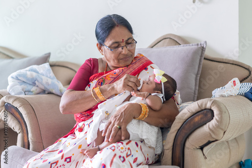 Photography ndian family spending time together, wearing traditional and casual outfits with a baby, a young girl, and grandparents in a high-rise apartment in Kuala Lumpur, Malaysia