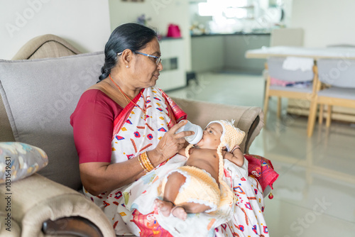 Photography ndian family spending time together, wearing traditional and casual outfits with a baby, a young girl, and grandparents in a high-rise apartment in Kuala Lumpur, Malaysia