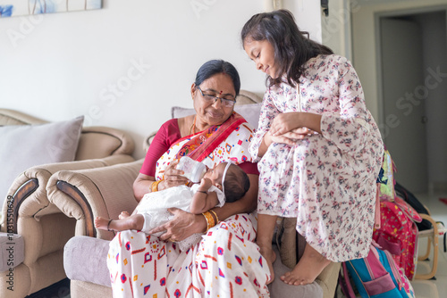 Photography ndian family spending time together, wearing traditional and casual outfits with a baby, a young girl, and grandparents in a high-rise apartment in Kuala Lumpur, Malaysia