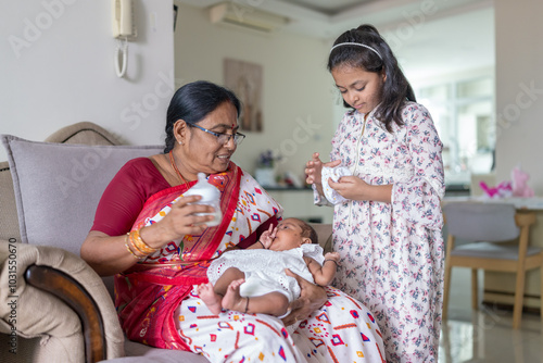 Photography ndian family spending time together, wearing traditional and casual outfits with a baby, a young girl, and grandparents in a high-rise apartment in Kuala Lumpur, Malaysia