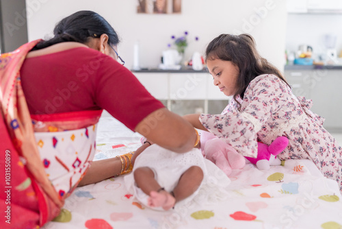 Photography ndian family spending time together, wearing traditional and casual outfits with a baby, a young girl, and grandparents in a high-rise apartment in Kuala Lumpur, Malaysia