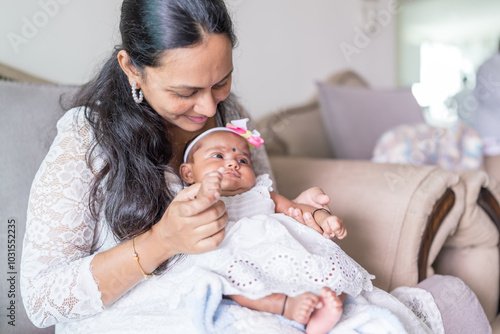 Canvas Print ndian family spending time together, wearing traditional and casual outfits with a baby, a young girl, and grandparents in a high-rise apartment in Kuala Lumpur, Malaysia