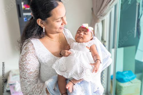 Photography ndian family spending time together, wearing traditional and casual outfits with a baby, a young girl, and grandparents in a high-rise apartment in Kuala Lumpur, Malaysia
