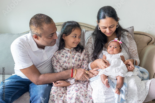Photography ndian family spending time together, wearing traditional and casual outfits with a baby, a young girl, and grandparents in a high-rise apartment in Kuala Lumpur, Malaysia