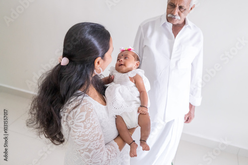 Photography ndian family spending time together, wearing traditional and casual outfits with a baby, a young girl, and grandparents in a high-rise apartment in Kuala Lumpur, Malaysia