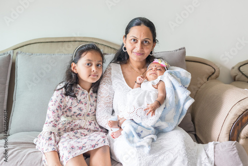 Photography ndian family spending time together, wearing traditional and casual outfits with a baby, a young girl, and grandparents in a high-rise apartment in Kuala Lumpur, Malaysia