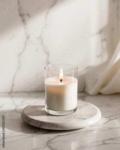 Serene Single White Candle in Glass Holder on Marble Surface with Soft Blurred Background.