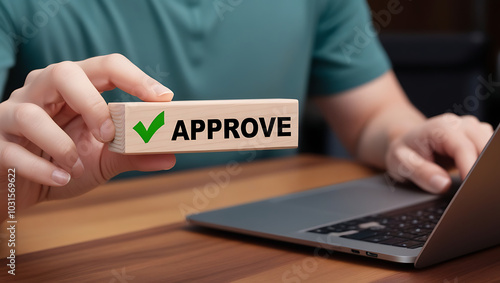 Approved. Businessman holding wooden block with text approve for document approval, assessment, approve the loan, finance agreement, loan, stamp, business. Certified