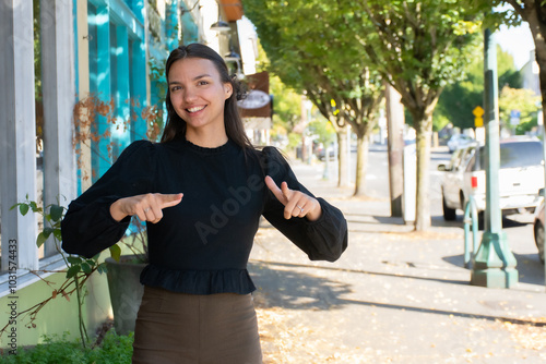 Sign Language Interpreter signs 'language' in ASL photo